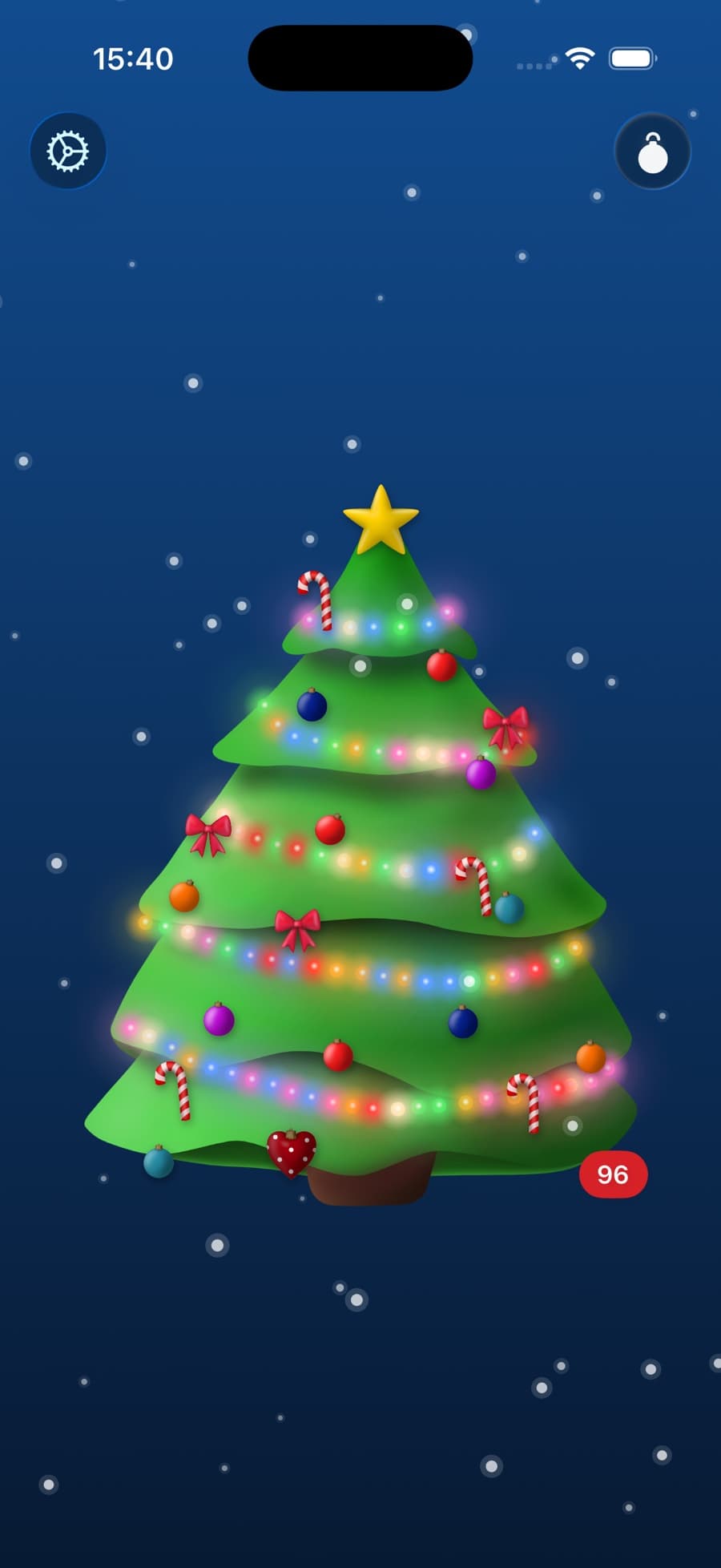 The decorated tree on iPhone, with snow falling and 96 days on the badge